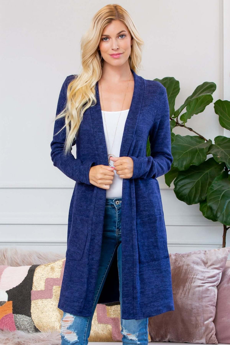 Model wearing a navy brushed sweater pocket cardigan, styled with skinny jeans and a white top.