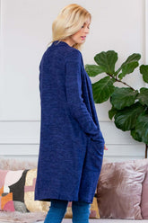 Model wearing a navy brushed sweater pocket cardigan, showcasing a long silhouette and side pockets.