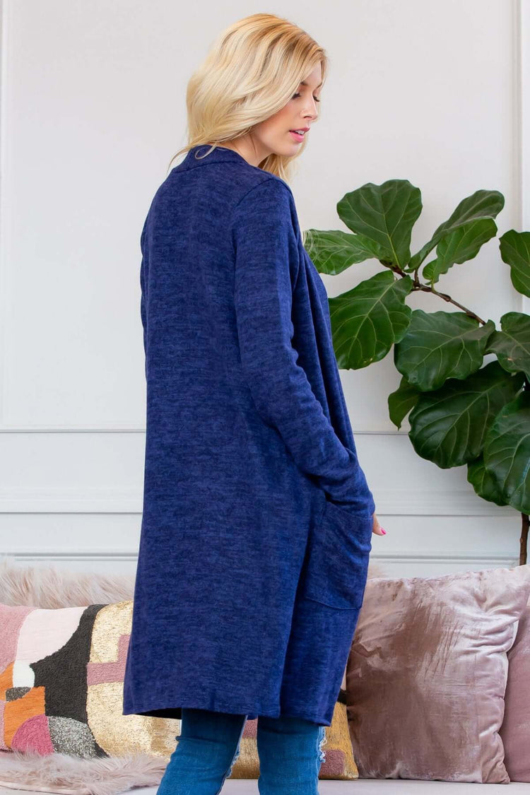 Model wearing a navy brushed sweater pocket cardigan, showcasing a long silhouette and side pockets.