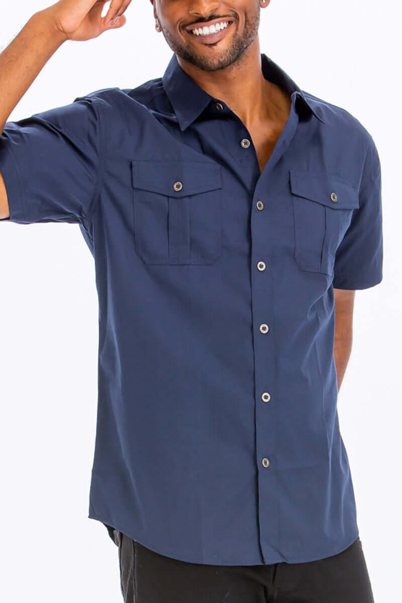 Short sleeve two pocket button down shirt in navy with branded buttons for men, made of cotton and polyester.