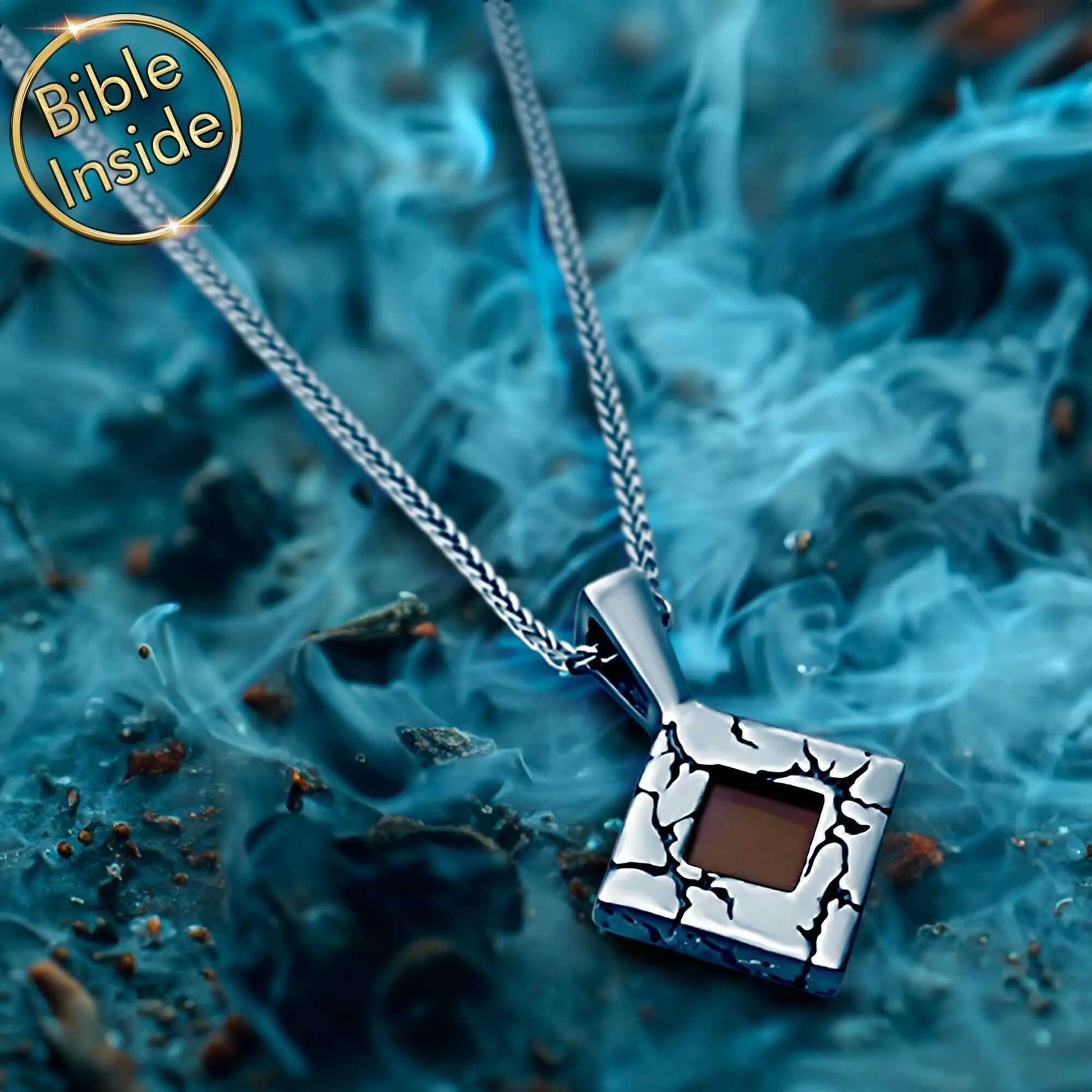 Nano Bible Jewelry with engraved rhombus pendant and Bible inside, surrounded by a smoky background, showcasing its unique design.