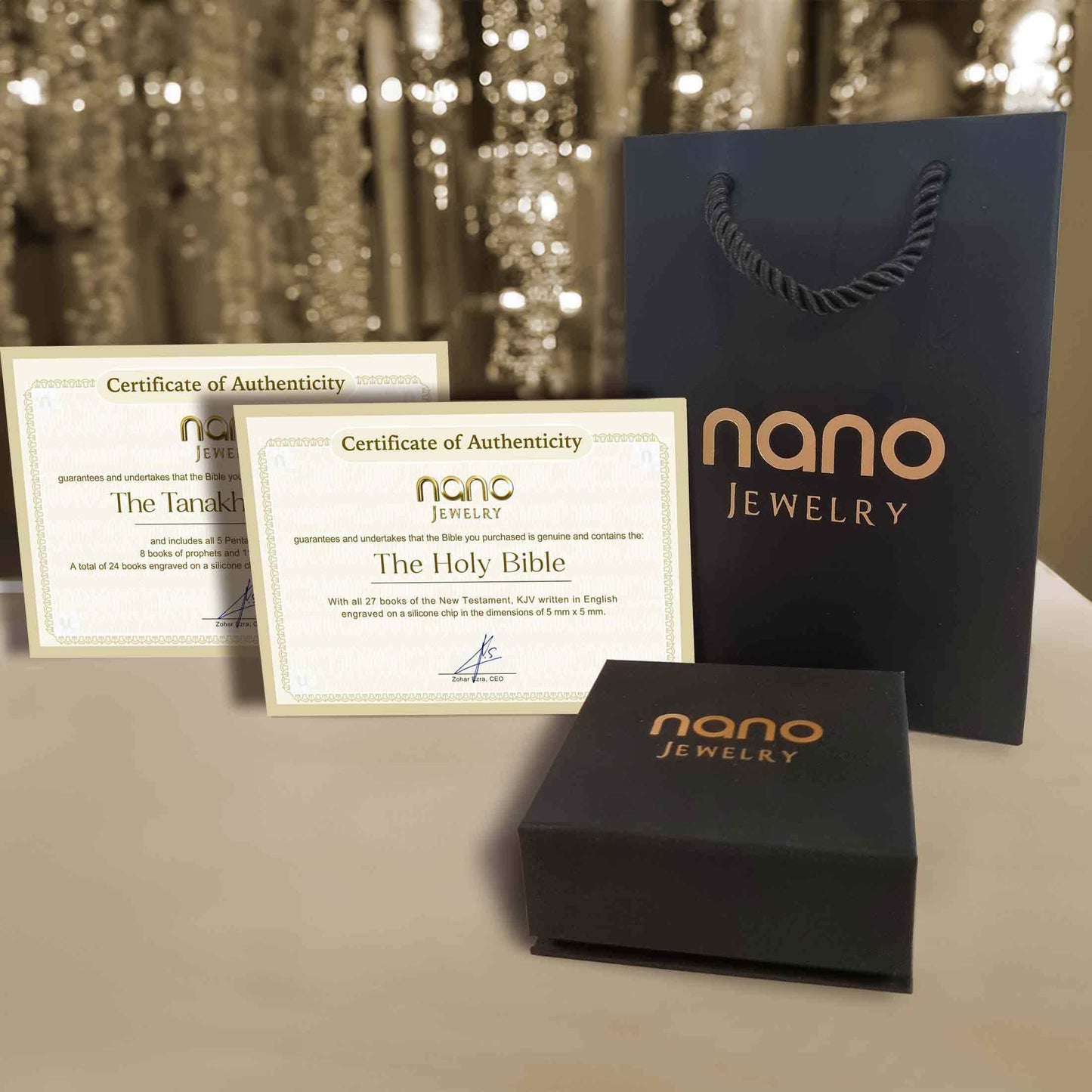 Certificates of authenticity for Nano Jewelry, featuring The Holy Bible and Tanakh, displayed with packaging.