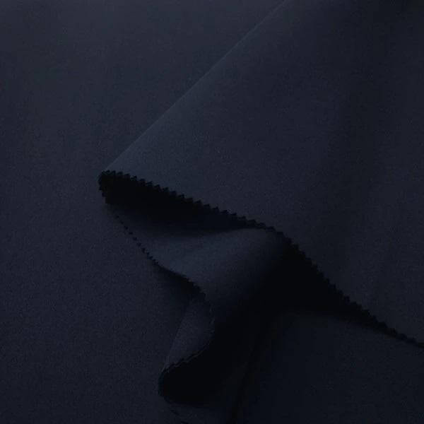 Close-up of dark navy neoprene fabric, showcasing its smooth texture and clean edges.