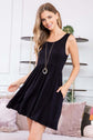 Stylish racerback tank dress with flared silhouette and pockets, perfect for summer. Model wearing a black sleeveless dress.