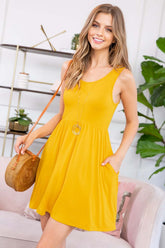 Yellow racerback tank dress with on-seam pockets, styled with a round pendant and woven bag.