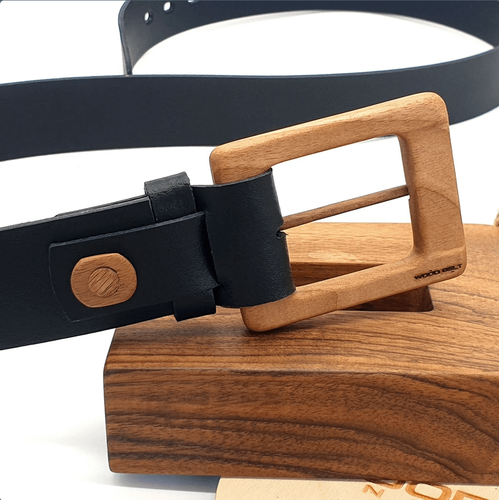 Luxury men's leather belt with wooden buckle on a walnut display, showcasing a minimalistic design and 40mm width.