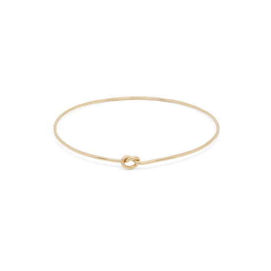 Elegant Shelby Love Knot Bangle in gold, featuring a unique knot design for a stylish accessory.