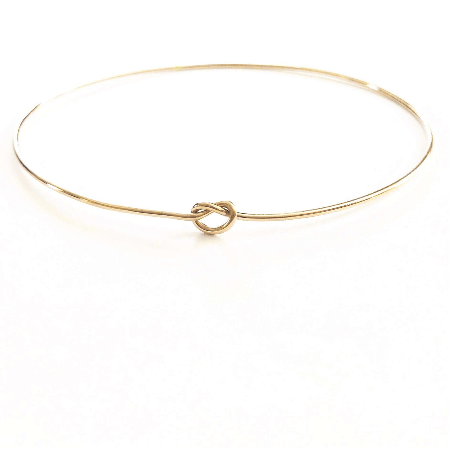 Shelby Love Knot Bangle showcasing elegant design with a unique love knot, perfect for enhancing any outfit.