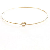 Shelby Love Knot Bangle showcasing elegant design with a unique love knot, perfect for enhancing any outfit.
