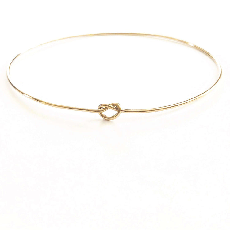 Shelby Love Knot Bangle showcasing elegant design with a unique love knot, perfect for enhancing any outfit.