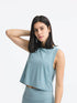 Millennia Round Neck Cropped Active Tank in light blue, showcasing a stylish and stretchy design, perfect for workouts.