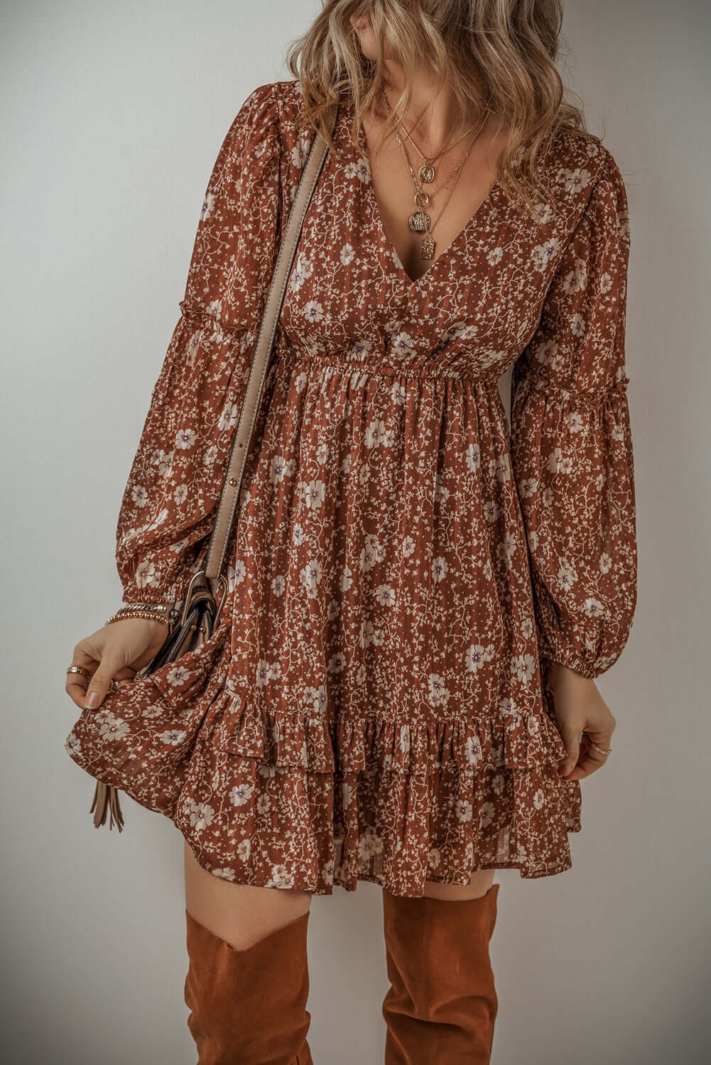 Ashley Boho floral puff sleeve mini dress with ruffles, V-neckline, and earthy brown color showcasing a feminine charm.