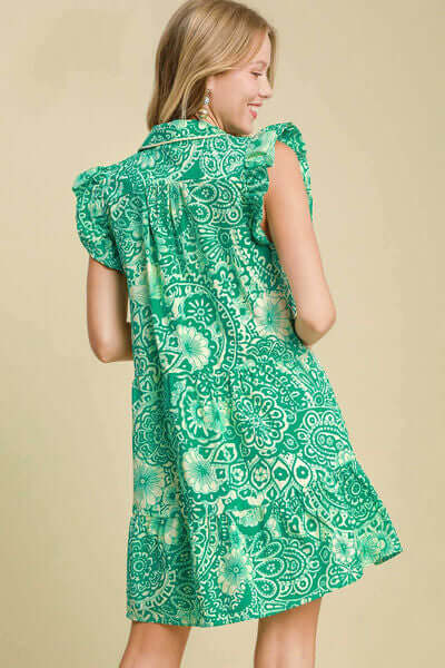 Model showing back view of Umgee green printed ruffle cap sleeve babydoll dress plus size.