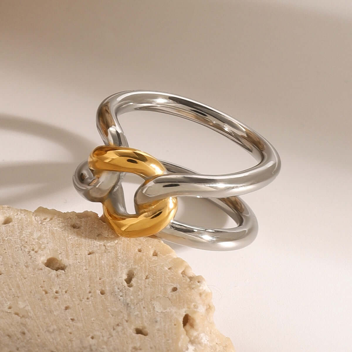 18K gold-plated ring with hollow design in gold and silver, showcasing modern elegance and luxury.