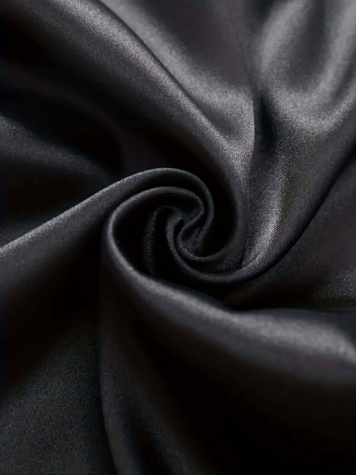 Close-up of luxurious black ice silk fabric showcasing its smooth and soft texture, perfect for pajamas.