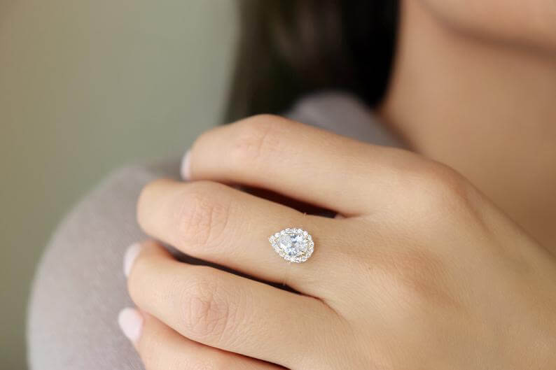 Sterling Silver Floating Pear Shaped Ring with Cubic Zirconia, showcasing elegant halo design on model's hand.