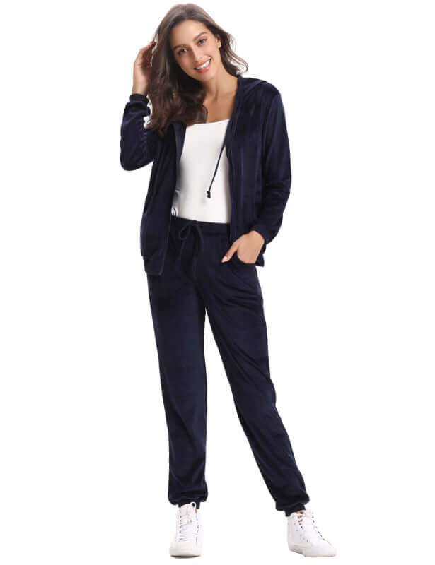 Woman in navy blue cozy knit two-piece set, featuring a zip-up hoodie and matching jogger pants.