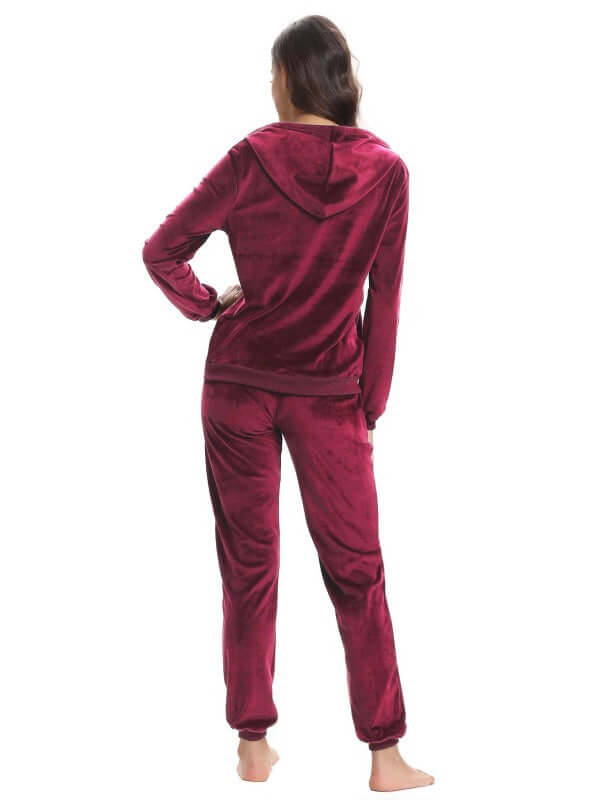 Back view of women's cozy knit two-piece set in burgundy, featuring a hooded top and matching pants.