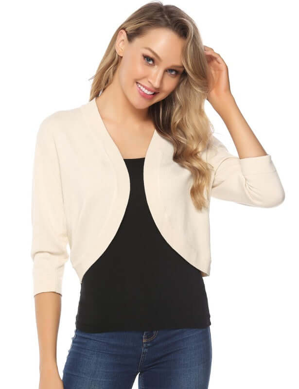 Woman wearing a women's 3/4 sleeve cropped cardigan over a black top, styled for a casual look.