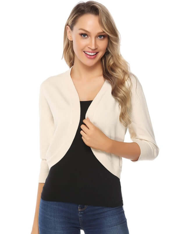 Woman wearing a stylish women's 3/4 sleeve cropped cardigan over a black top, showcasing a casual, layered look.