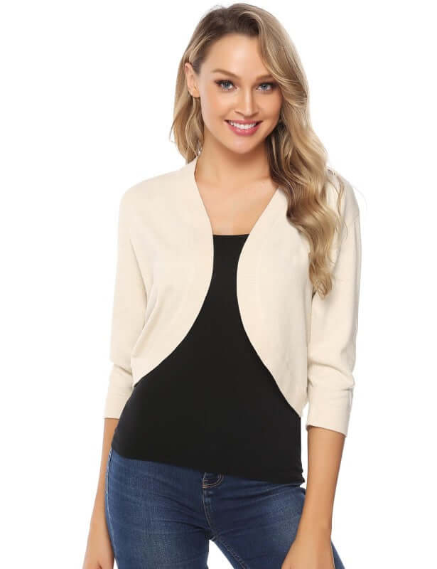 Women's 3/4 sleeve cropped cardigan in beige, paired with a black top, perfect for casual layering.