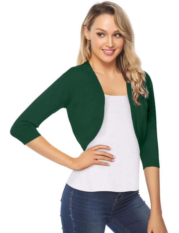 Woman wearing a green 3/4 sleeve cropped cardigan over a white top, showcasing a casual, stylish look.