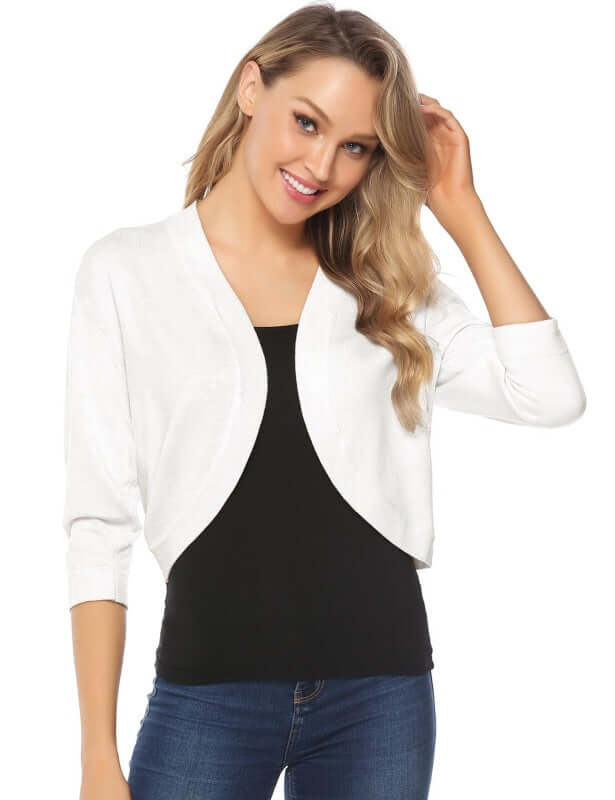 Model wearing a Women's 3/4 Sleeve Cropped Cardigan in white, paired with a black top and jeans.