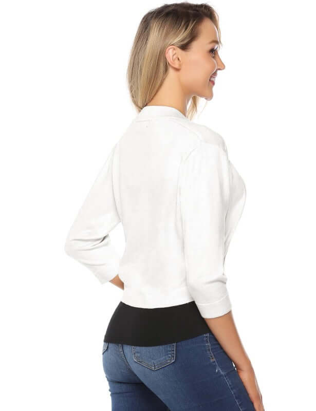 Back view of a Women's 3/4 Sleeve Cropped Cardigan in white, styled with jeans, showcasing its casual elegance.