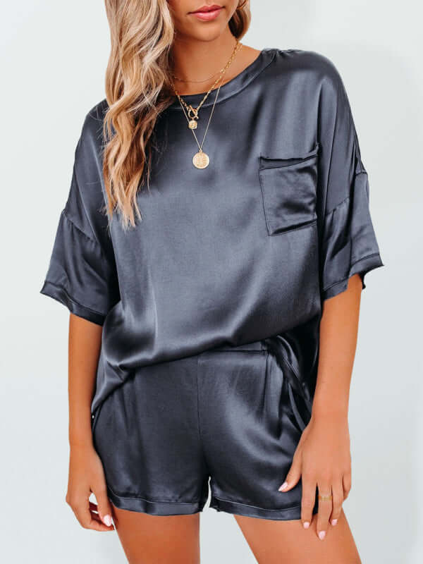 Women's satin pajamas two-piece set in black, featuring short sleeves and a pocket, perfect for home leisure.