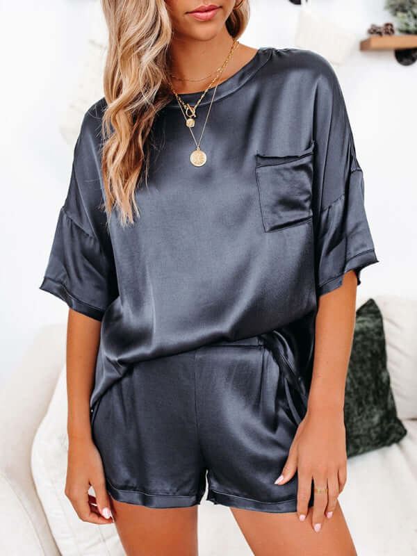 Women's short-sleeved satin pajamas set with pocket in dark color, ideal for home leisure wear in spring and summer.