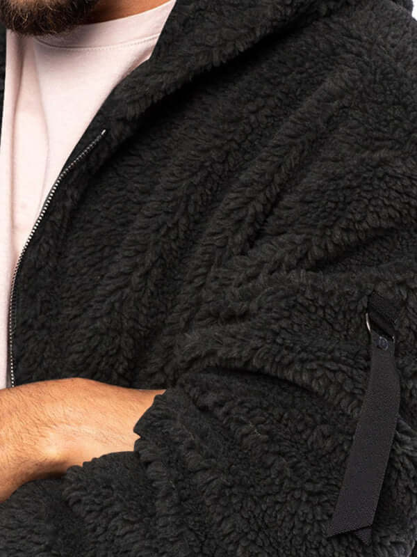 Close-up of a man wearing a loose hooded men's warm jacket, showcasing its soft fleece texture and casual style.