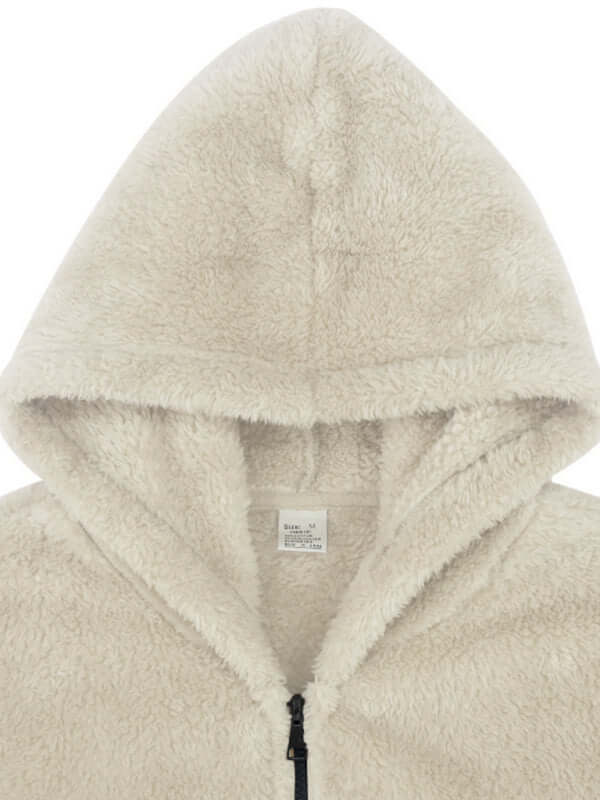 Close-up of a beige fuzzy hooded jacket showcasing its soft texture and casual style.