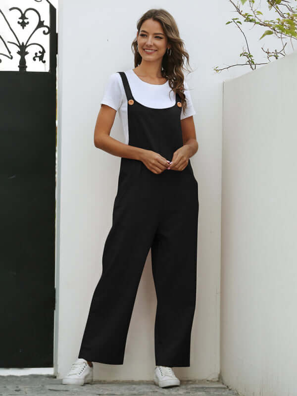 Woman wearing black woven retro casual long overalls with a white t-shirt, styled for spring-summer fashion.