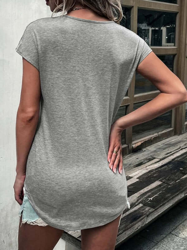 Back view of a woman in a grey short sleeve t-shirt, showcasing a casual and comfortable style.