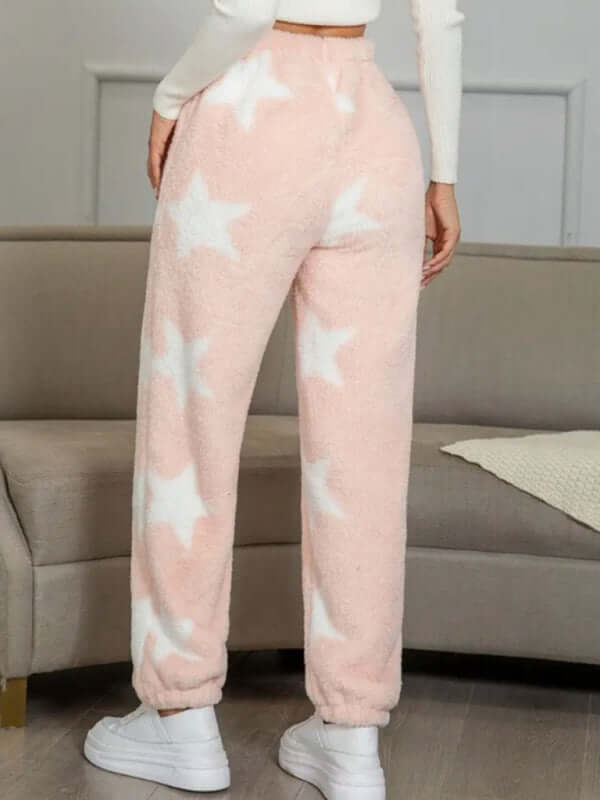 Back view of soft coral fleece pajamas with white star pattern, ideal for autumn and winter styling.