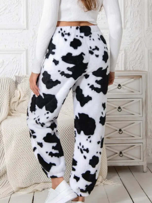 Back view of black and white cow print coral fleece pajamas for autumn-winter wear.