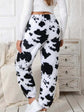 Back view of black and white cow print coral fleece pajamas for autumn-winter wear.