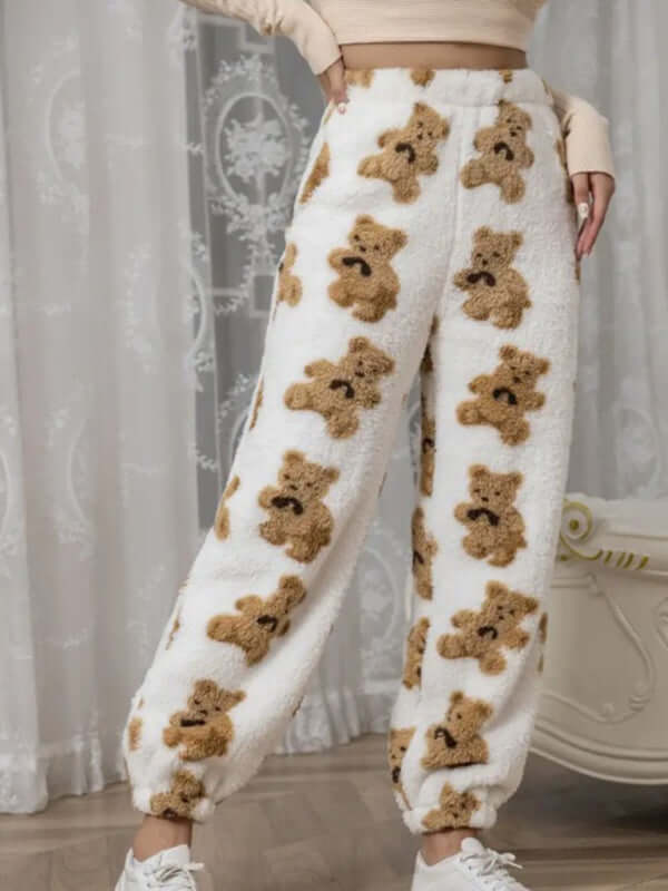 Cozy coral fleece pajama pants featuring a cute teddy bear pattern, perfect for autumn-winter loungewear.