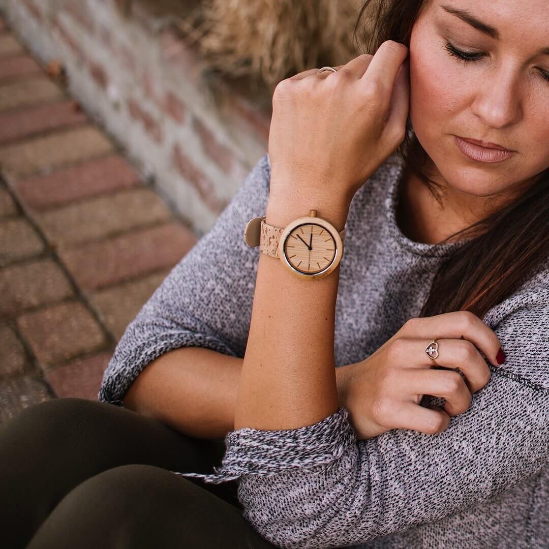 Woman wearing The Naturalist Eco-Friendly Panda Watch with bamboo and cork design, showcasing modern minimalist style.