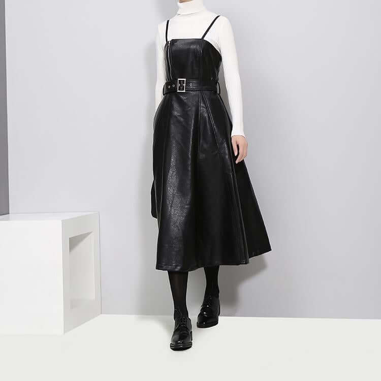 Knee-length A-line Musset vegan leather dress in black with spaghetti straps and a natural waistline.